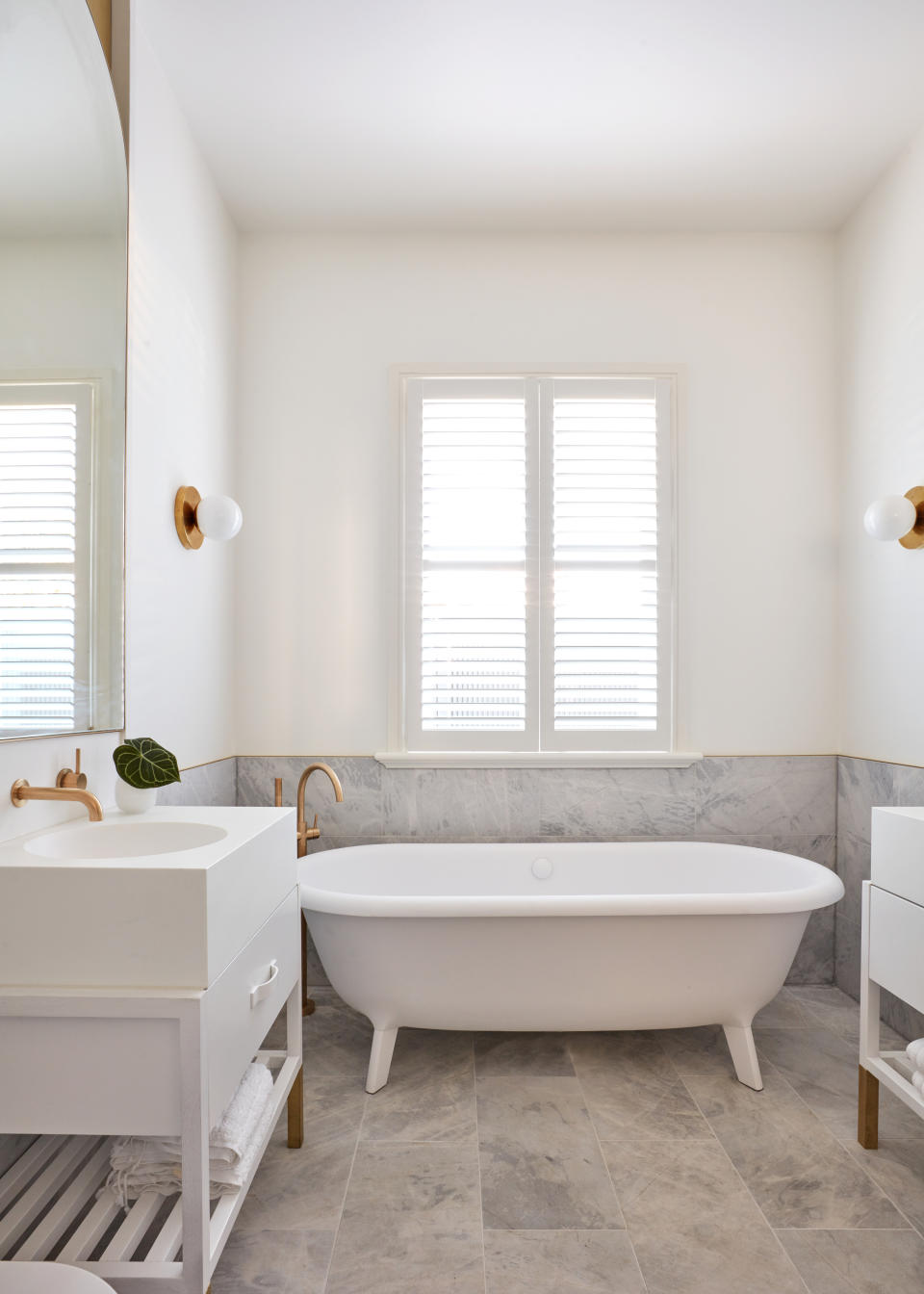 A bathroom window with a shutter