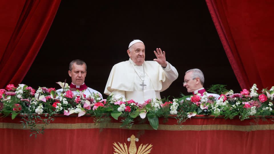 Pope Francis waves from a balcony on Easter Sunday. Francis called for an "immediate ceasefire" during his address. - Yara Nardi/Reuters