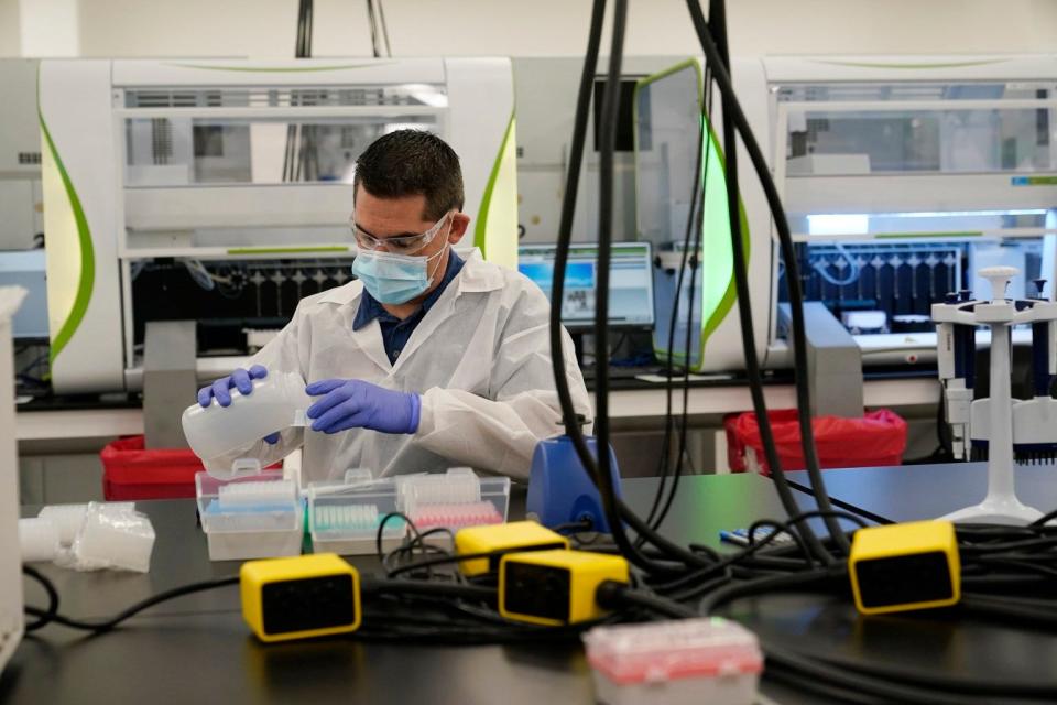 A technician conducts coronavirus tests in Valencia, Calif.