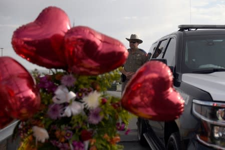 People pay their respects four days after a mass shooting in El Paso