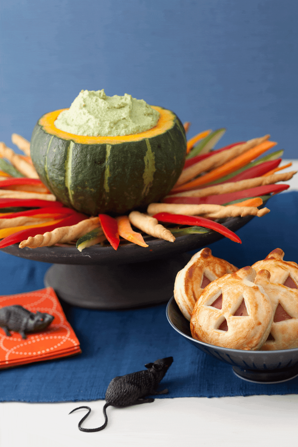 <p>What's a Halloween party without a green dip? Made from good-for-you edamame and low-fat ricotta cheese, you can serve this crowd-pleaser in a large acorn squash atop a "fire" of crudité and breadsticks.</p><p><strong><em><a href="https://www.womansday.com/food-recipes/food-drinks/recipes/a11350/cauldron-dip-recipe-122710/" rel="nofollow noopener" target="_blank" data-ylk="slk:Get the Cauldron Dip recipe.;elm:context_link;itc:0;sec:content-canvas" class="link ">Get the Cauldron Dip recipe. </a></em></strong></p>