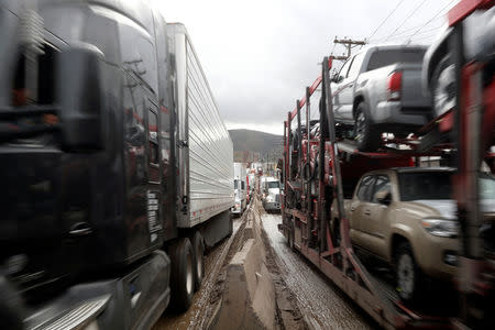 Trucks moves slowly in long queue at border customs control to cross into the U.S, caused by the redeployment of border officers to deal with a surge in migrants, at the Otay border crossing in Tijuana, Mexico April 3, 2019. REUTERS/Carlos Jasso