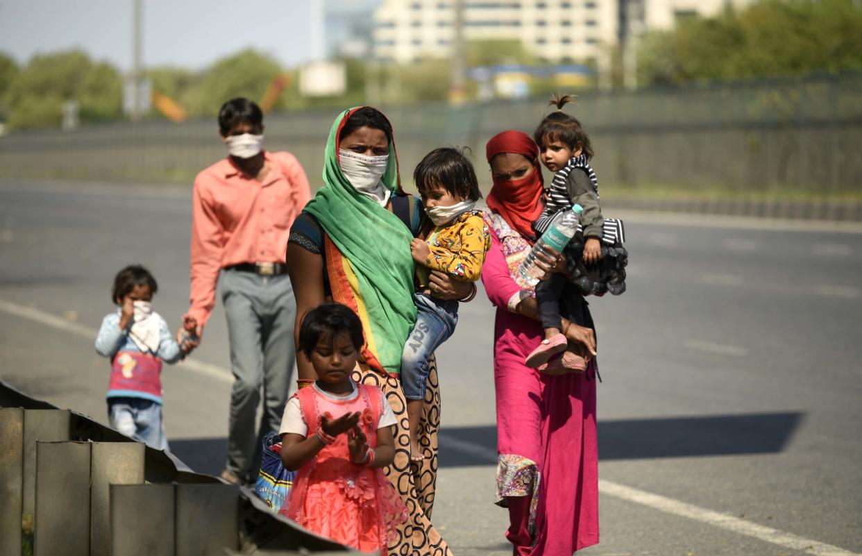 Migrant workers with children headed home on foot, on day 5 of the 21 day nationwide lockdown imposed in India. Photo by Parveen Kumar/Hindustan Times via Getty Images