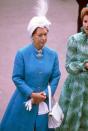 <p>The Princess wears a feather-topped head wrap and bright blue coat to Royal Ascot in 1981.</p>