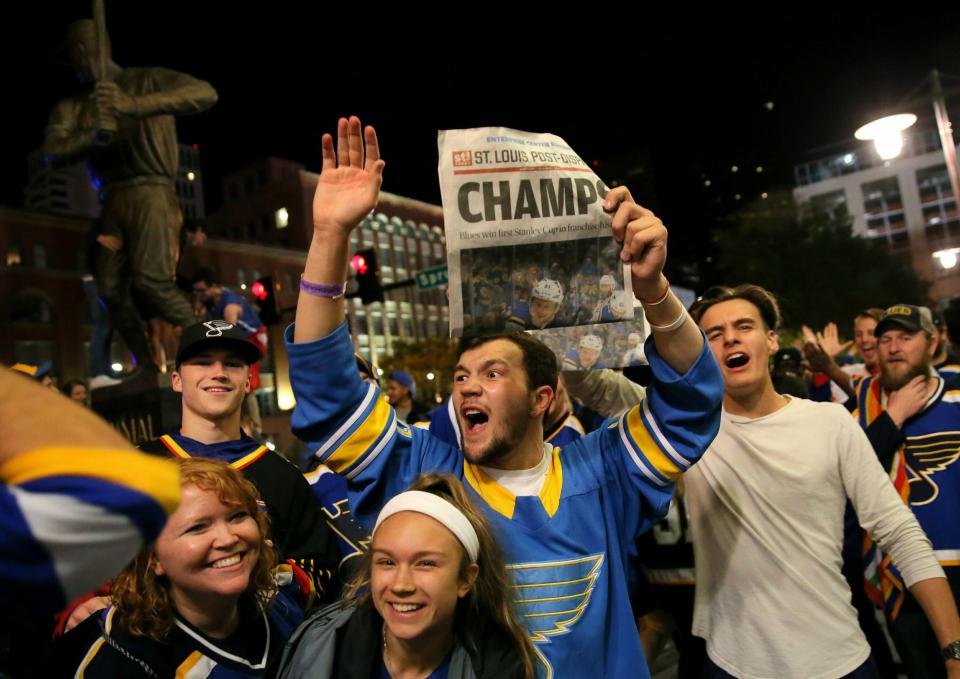 St. Louis Blues fans celebrate the team's victory over the Boston Bruins in Boston in Game 7 of the NHL hockey Stanley Cup Final, outside Busch Stadium in St. Louis after a watch party for the game was held in the baseball stadium Wednesday, June 12, 2019. (David Carson/St. Louis Post-Dispatch via AP)