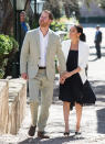 <p>To visit an arts and crafts display in the Andolusian Gardens, the pregnant royal chose a black plisse dress by Loyd/Ford. To accessorise, Meghan also wore her white Babaton ‘Keith’ Jacket and Manolo Blahnik polka dot slingback pumps. <em>[Photo: Getty]</em> </p>