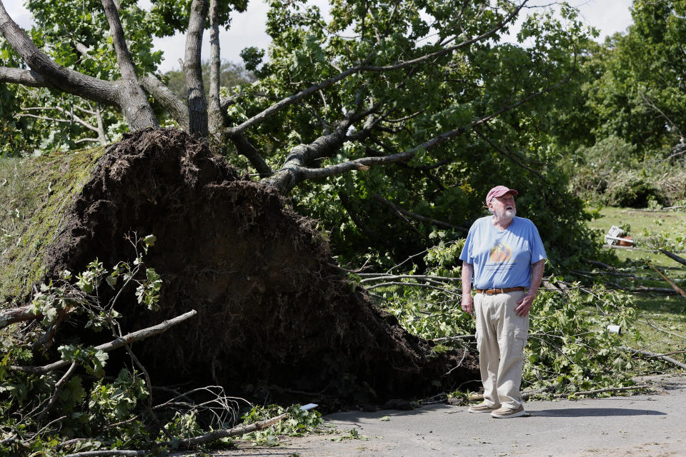 Highland Memorial Park Cemetery president Joe Swift inspects damage to the grounds, Friday, Aug. 18, 2023, in Johnston, R.I., after severe weather swept through the area Friday morning. (AP Photo/Michael Dwyer)