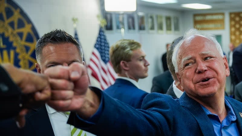 Democratic vice presidential nominee Minnesota Gov. Tim Walz fist bumps a supporter during a campaign rally at UAW Local 900, Thursday, Aug. 8, 2024, in Wayne, Mich.