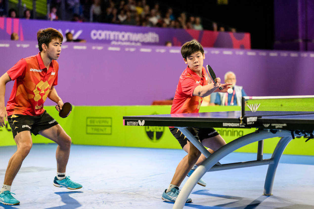 Singapore paddlers Koen Pang (left) and Izaac Quek in action in the men's team final at the 2022 Commonwealth Games in Birmingham. (PHOTO: Commonwealth Games Singapore/Andy Chua)