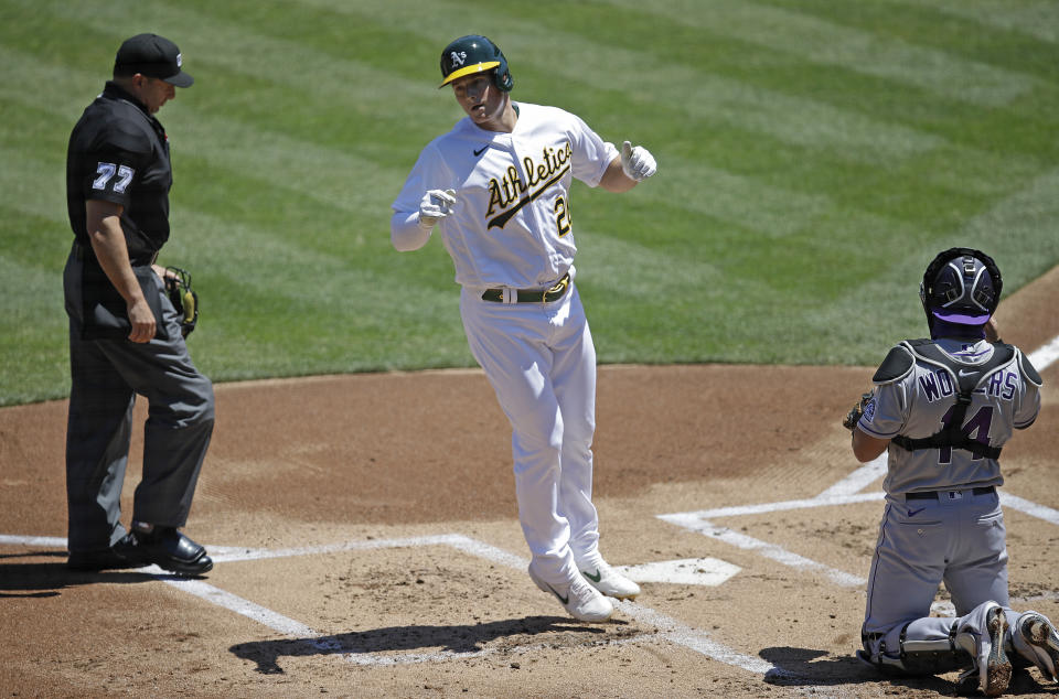 Oakland Athletics' Matt Chapman steps off home plate after hitting a home run off Colorado Rockies pitcher German Marquez in the first inning of a baseball game Wednesday, July 29, 2020, in Oakland, Calif. At right is Rockies' catcher Tony Wolters. (AP Photo/Ben Margot)