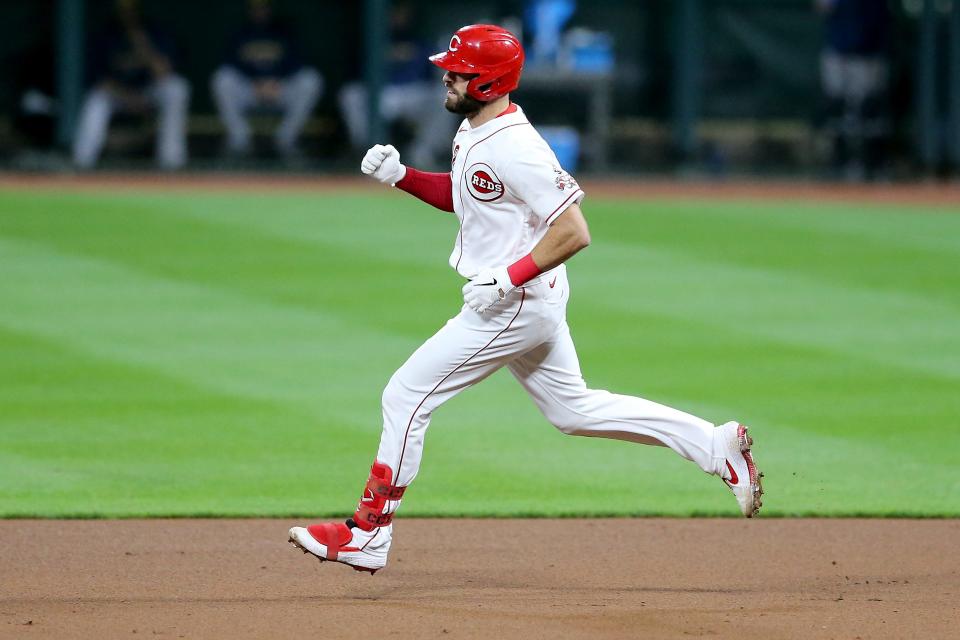 Cincinnati Reds catcher Curt Casali (12) rounds the bases after hitting a solo home run in the eighth inning of a baseball game against the Milwaukee Brewers, Monday, Sept. 21, 2020, at Great American Ball Park in Cincinnati. The Cincinnati Reds won, 6-3.