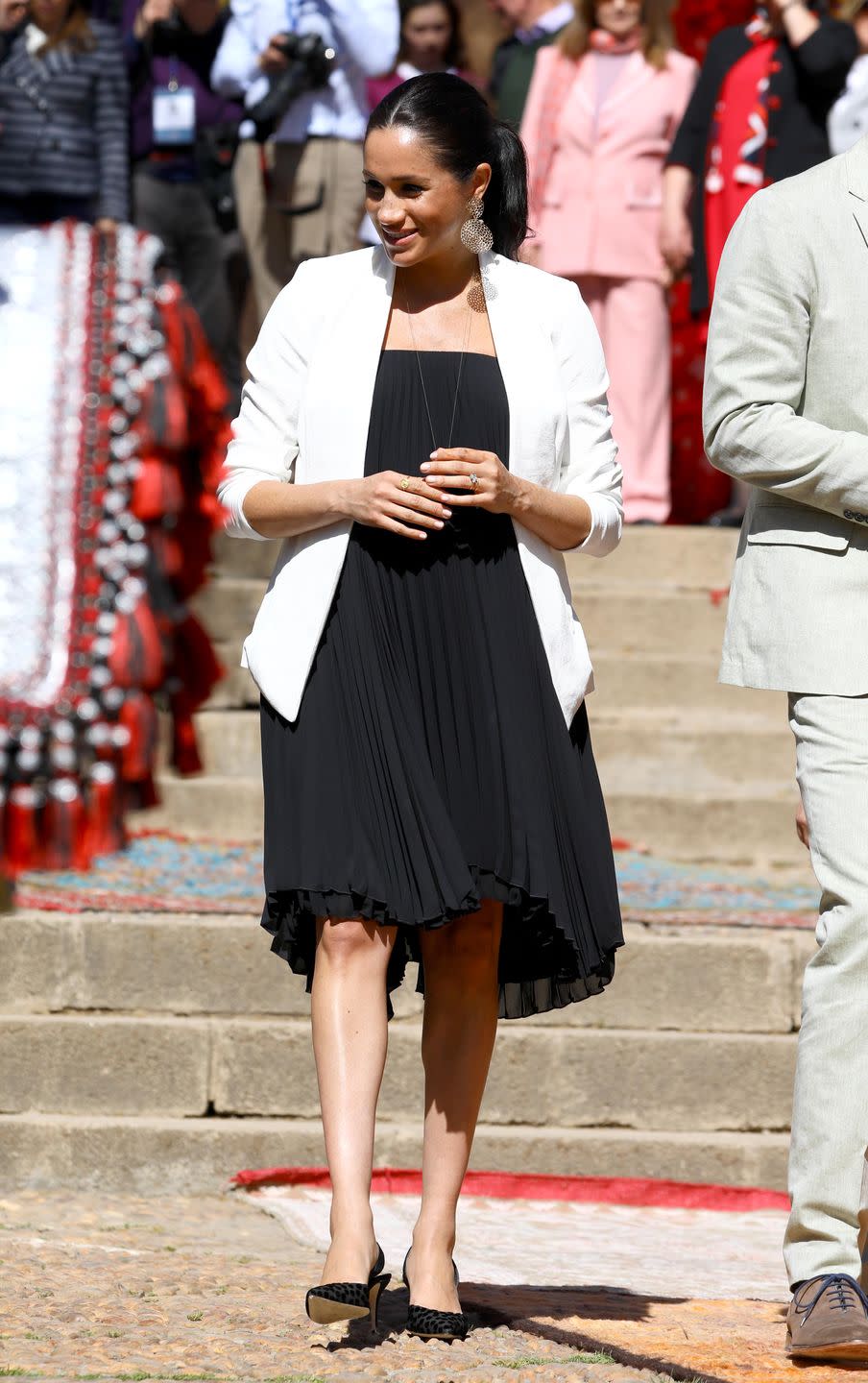 <p>Meghan looked glamorous for a public walk through of the Andalusian Gardens in Rabat wearing a black pleated dress, white blazer from Aritzia, large <a href="https://go.redirectingat.com?id=74968X1596630&url=https%3A%2F%2Fwww.neimanmarcus.com%2Fp%2Fgas-bijoux-onde-drop-earrings-prod220120063&sref=https%3A%2F%2Fwww.townandcountrymag.com%2Fstyle%2Ffashion-trends%2Fg3272%2Fmeghan-markle-preppy-style%2F" rel="nofollow noopener" target="_blank" data-ylk="slk:gold statement earrings by Gas Bijoux;elm:context_link;itc:0;sec:content-canvas" class="link ">gold statement earrings by Gas Bijoux </a>and black Manolo Blahnik sling back heels. </p><p><a class="link " href="https://go.redirectingat.com?id=74968X1596630&url=https%3A%2F%2Fwww.saksfifthavenue.com%2Fmanolo-blahnik-carolyne-suede-slingbacks%2Fproduct%2F0400088941109&sref=https%3A%2F%2Fwww.townandcountrymag.com%2Fstyle%2Ffashion-trends%2Fg3272%2Fmeghan-markle-preppy-style%2F" rel="nofollow noopener" target="_blank" data-ylk="slk:Shop Now;elm:context_link;itc:0;sec:content-canvas">Shop Now</a> <em>Carolyne Suede Slingbacks, Manolo Blahnik, $645</em></p><p><a class="link " href="https://go.redirectingat.com?id=74968X1596630&url=https%3A%2F%2Fwww.neimanmarcus.com%2Fp%2Fgas-bijoux-onde-drop-earrings-prod220120063&sref=https%3A%2F%2Fwww.townandcountrymag.com%2Fstyle%2Ffashion-trends%2Fg3272%2Fmeghan-markle-preppy-style%2F" rel="nofollow noopener" target="_blank" data-ylk="slk:Shop Now;elm:context_link;itc:0;sec:content-canvas">Shop Now</a> <em>Onde Drop Earrings, Gas Bijoux, $200</em></p>