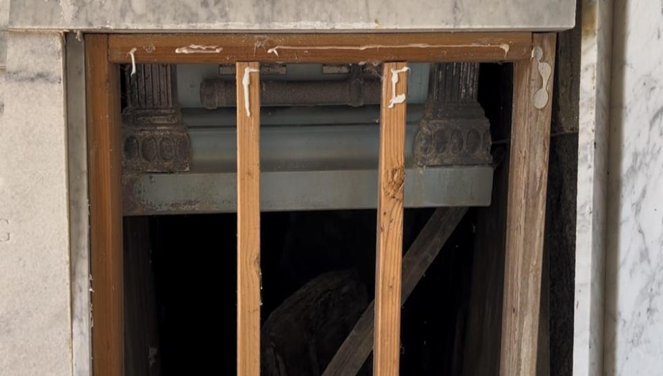 A casket is partially exposed in the Lillis Morgen mausoleum where time, a tornado, vandals, water and ground settling at Rosemont Cemetery have taken a toll.