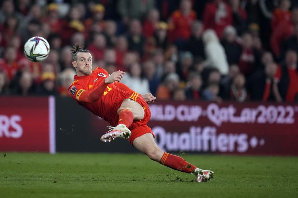 FILE - Wales' Gareth Bale takes a shot during the World Cup 2022 playoff soccer match between Wales and Austria at Cardiff City stadium, in Cardiff, Britain, Thursday, March 24, 2022. Gareth Bale is retiring from soccer at age 33 after setting a Wales record with 41 international goals. “My decision to retire from International football has been by far the hardest of my career,” Bale said in a statement Monday, Jan. 9, 2023. (AP Photo/Matt Dunham, File)