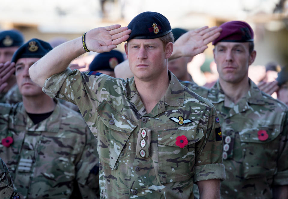 KANDAHAR, AFGHANISTAN - NOVEMBER 09:  Prince Harry salutes as the Last Post is played as he joins British troops and service personal remaining in Afghanistan and also International Security Assistance Force (ISAF) personnel and civilians as they gather for a Remembrance Sunday service at Kandahar Airfield November 9, 2014 in Kandahar, Afghanistan. As the UK combat mission in Afghanistan draws to an end in 2014 this year, which also marks the 100th anniversary of the start of World War One, 70 years since the D-Day landings will be the last time British service personal will gather in any great numbers in the south of the country.  (Photo by Matt Cardy/Getty Images)