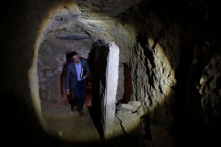 Archaeologist Musab Mohammed Jassim shows artefacts and archaeological pieces in a tunnel network running under the Mosque of Prophet Jonah, Nabi Yunus in Arabic, in eastern Mosul, Iraq March 9, 2017. Picture taken March 9, 2017. REUTERS/Suhaib Salem