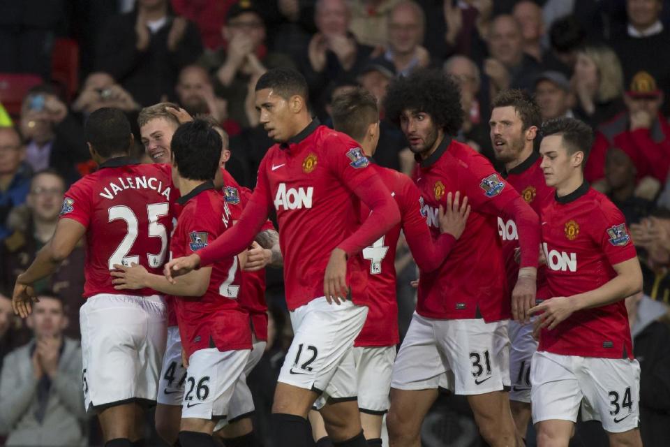 Manchester United's James Wilson, second left, celebrates with teammates after scoring past Hull City's goalkeeper Eldin Jakupovic during their English Premier League soccer match at Old Trafford Stadium, Manchester, England, Tuesday May 6, 2014. (AP Photo/Jon Super)