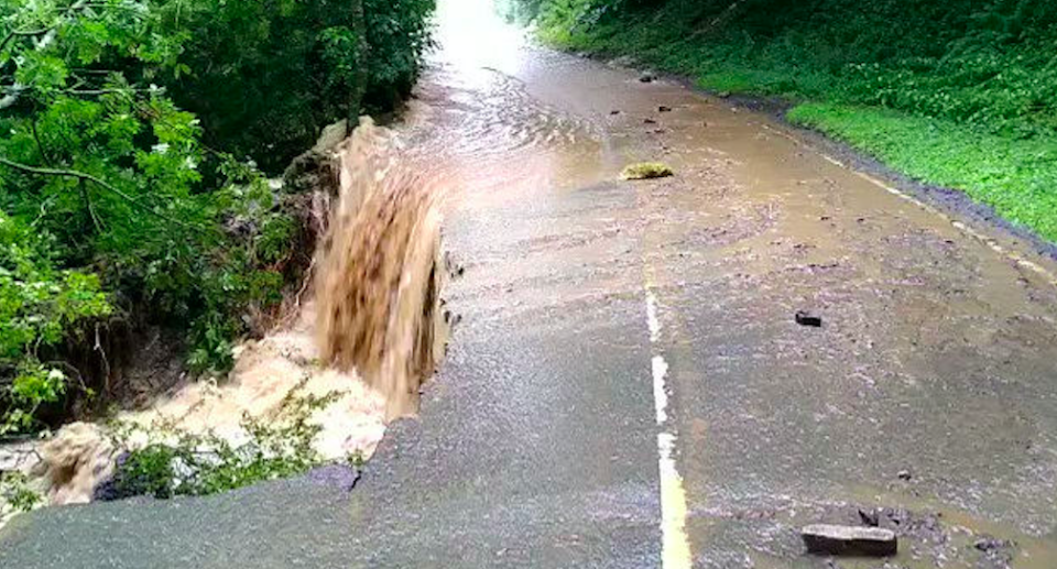 A damaged road and floodwater on the B6270 between Downhome and Grinton, North Yorkshire (Twitter/@OscarRomeo1268/PA)