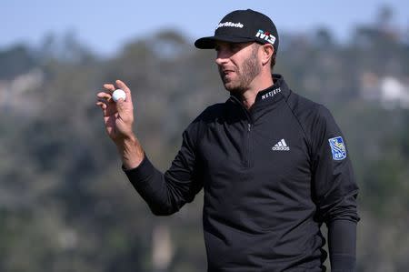 Feb 10, 2018; Pebble Beach, CA, USA; Dustin Johnson acknowledges the crowd after a putt on the sixth green during the third round of the AT&T Pebble Beach Pro-Am golf tournament at Pebble Beach Golf Links. Mandatory Credit: Orlando Ramirez-USA TODAY Sports