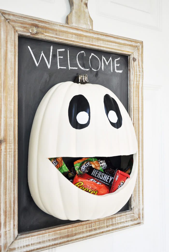 <p>Functional and fun, this pumpkin piece adds a festive touch to your front door while storing candy for guests to enjoy.</p><p><strong>Get the tutorial at <a href="https://cherishedbliss.com/diy-halloween-candy-door-hanger-recipe/" rel="nofollow noopener" target="_blank" data-ylk="slk:Cherished Bliss;elm:context_link;itc:0;sec:content-canvas" class="link ">Cherished Bliss</a>.</strong> </p>