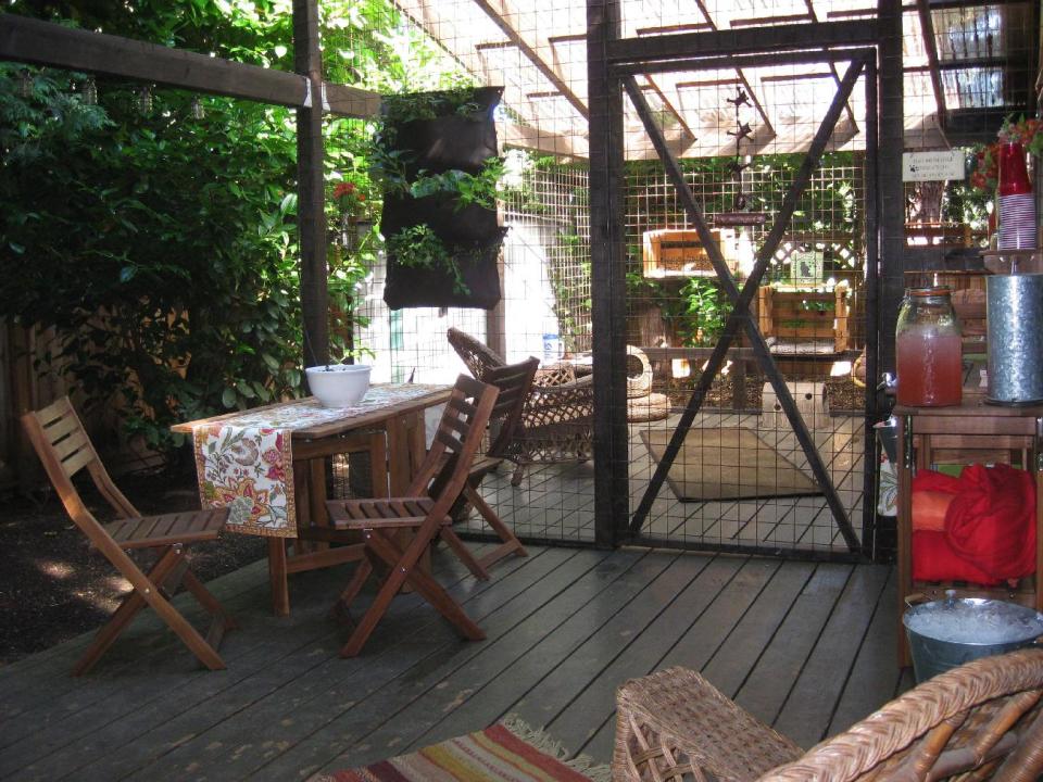 This undated photo provided by Carrie Fagerstrom shows Fagerstrom's catio which cost $5,000 to build at her home in Portland, Ore. The playground for cats has an 11 foot by 14 foot base and is 11 feet high, with mesh wiring on the sides and a clear roof. The room includes scratching posts, a small water fountain and plenty of toys to entertain her eight cats. (AP Photo, Carrie Fagerstrom)