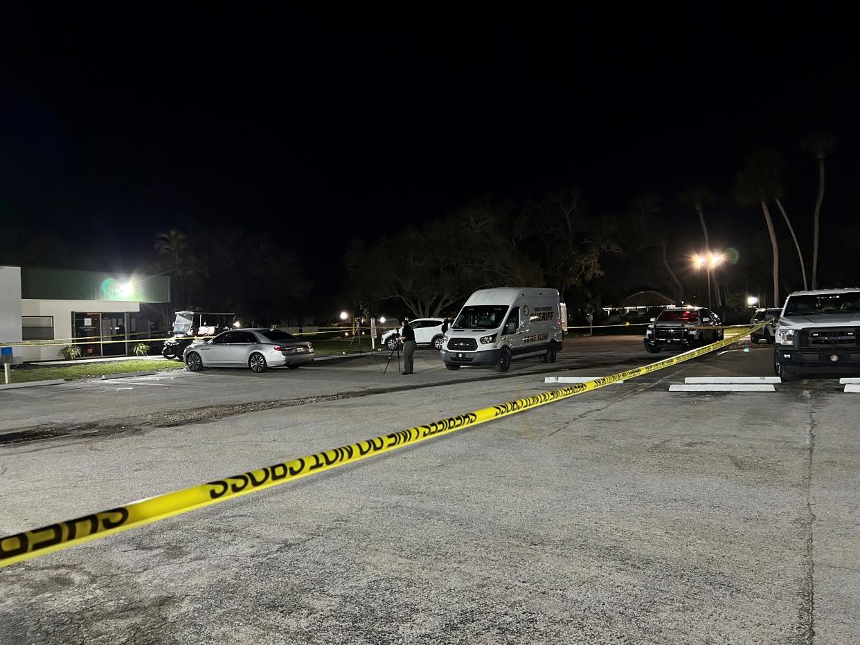 Gathered in the parking lot area of American Golf Club at 100 Woodland Drive, Indian River County Sheriff's Office crime scene investigators can be seen working outside an office area late into Monday, Feb. 19, 2024, following a fatal shooting that evening.