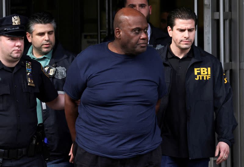FILE PHOTO: Frank James, the suspect in the Brooklyn subway shooting walks outside a police precinct in New York City