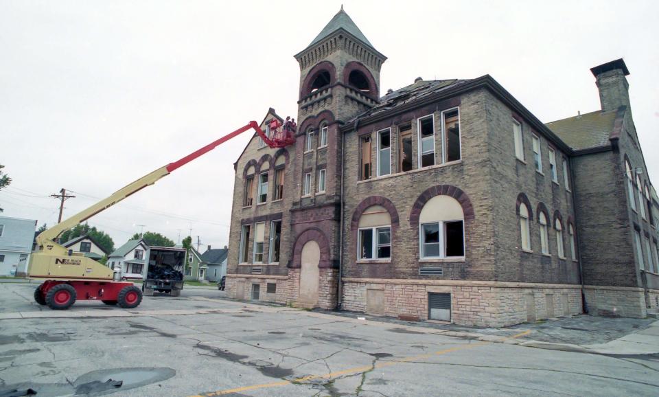 Employees of P & J Environmental Inc. work on the process of dismantling Longfellow Elementary School in Sheboygan, in this July 1993 file photo.