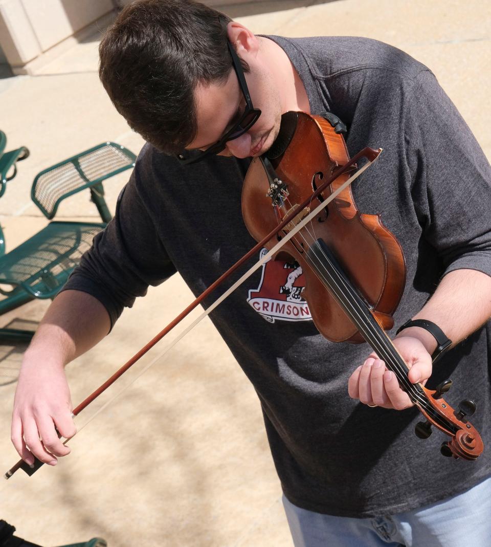 Feb 24, 2024; Tuscaloosa, Alabama, USA; Fiddle Fest 2024 features guitarists and fiddlers competed for the 2024 Southeast Fiddle Championship at Shelton State Saturday. Brandon Bounds works on the fiddle during a jam session.