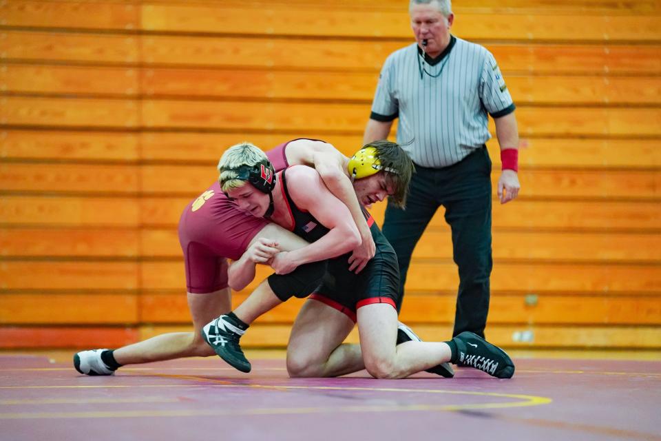 Edgewood’s Michael Neidigh (in black) wrestles against Bloomington North’s Miguel Tedrow in the 150-pound match during their dual meet at North on Tuesday, Jan. 9, 2024.