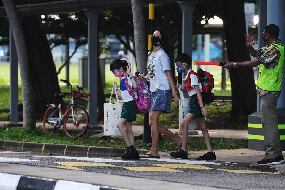 SINGAPORE, June 2, 2020 -- Primary school students wearing face masks are seen on their way to school in Singapore on June 2, 2020. Schools in Singapore reopened on Tuesday as the state embarked on a phased reopening from a COVID-19 "circuit breaker" period to curb the spread of the coronavirus. (Photo by Then Chih Wey/Xinhua via Getty) (Xinhua/xinjiapo via Getty Images)