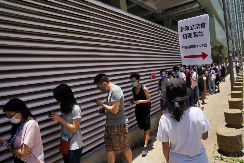 People line up to vote in the primary election aimed at selecting democracy candidates for the September election, in Hong Kong