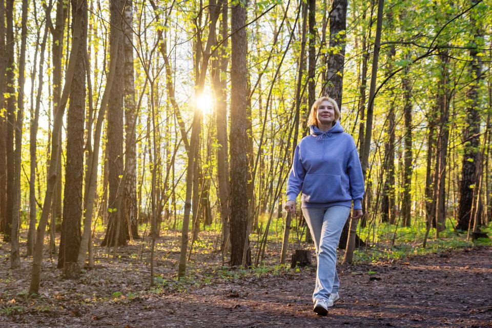 woman going for a walk in the forest