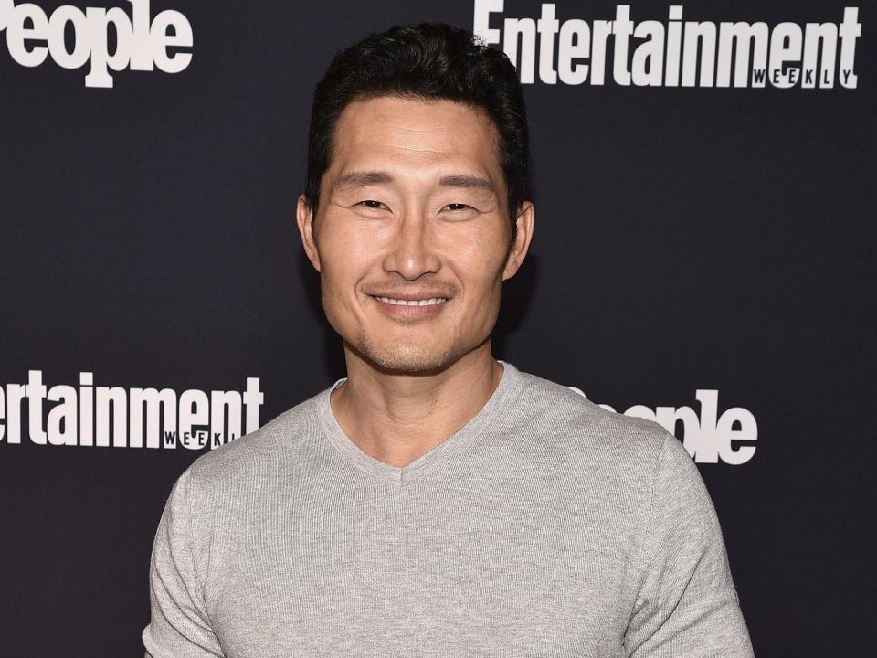 Daniel Dae Kim wears a grey sweater at an event