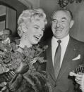 <p>Marilyn accepted flowers from Jack Warner, president of Warner Brothers, after Warner announced that Marilyn would star in a new film. </p>