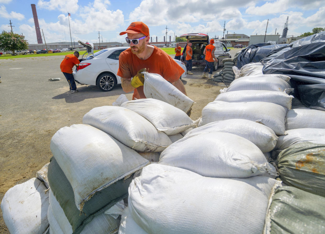 St. Bernard Parish Sheriff's Office inmate workers move free sandbags for residents in Chalmette, Louisiana, on Thursday. The Mississippi Emergency Management Agency is telling people in the southern part of the state to be prepared for heavy rain from Tropical Storm Barry.
