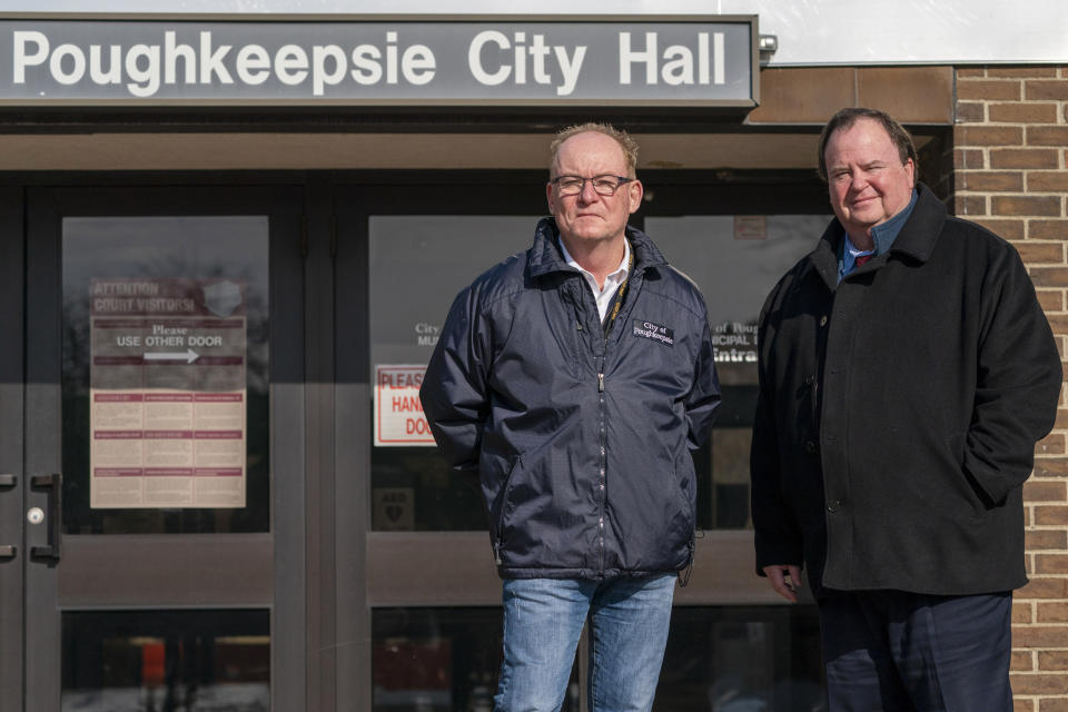 Poughkeepsie Mayor Robert Rolison, left, and City Administrator Marc Nelson pose for a photo outside City Hall in Poughkeepsie, N.Y., Tuesday, Jan. 25, 2022. Poughkeepsie was rated by the New York comptroller as the state’s most financially stressed community in 2020. The city has since received more than $20 million from the American Rescue Plan, which it is directing toward public works projects it otherwise couldn't afford. (AP Photo/Mary Altaffer)