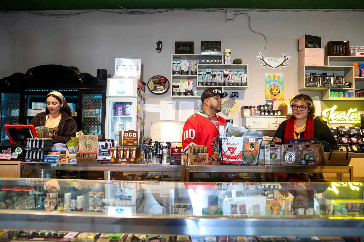 Reefer Madness budtender Jasmin Zarate, left, manager Gustavo Flores and supervisor Vasti Hinojo prepare for the afternoon rush Thursday at the cannabis dispensary in Palm Springs.