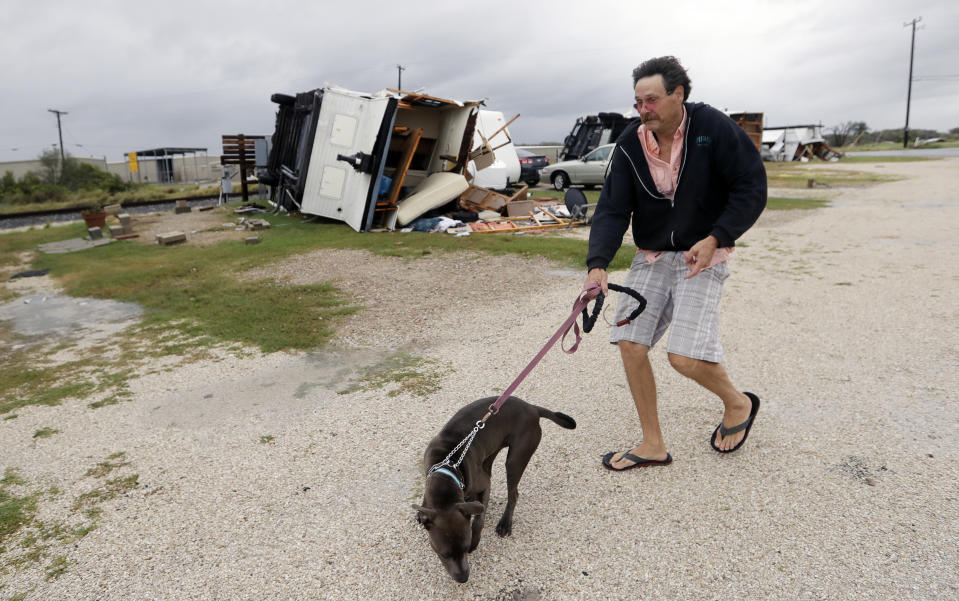 J.G. Roberson walks his dog, Peace, past a trailer overturned by the winds of Hurricane Harvey, Saturday, Aug. 26, 2017, in Aransas Pass, Texas. Roberson rode the storm out in his own trailer. (Photo: Eric Gay/AP)