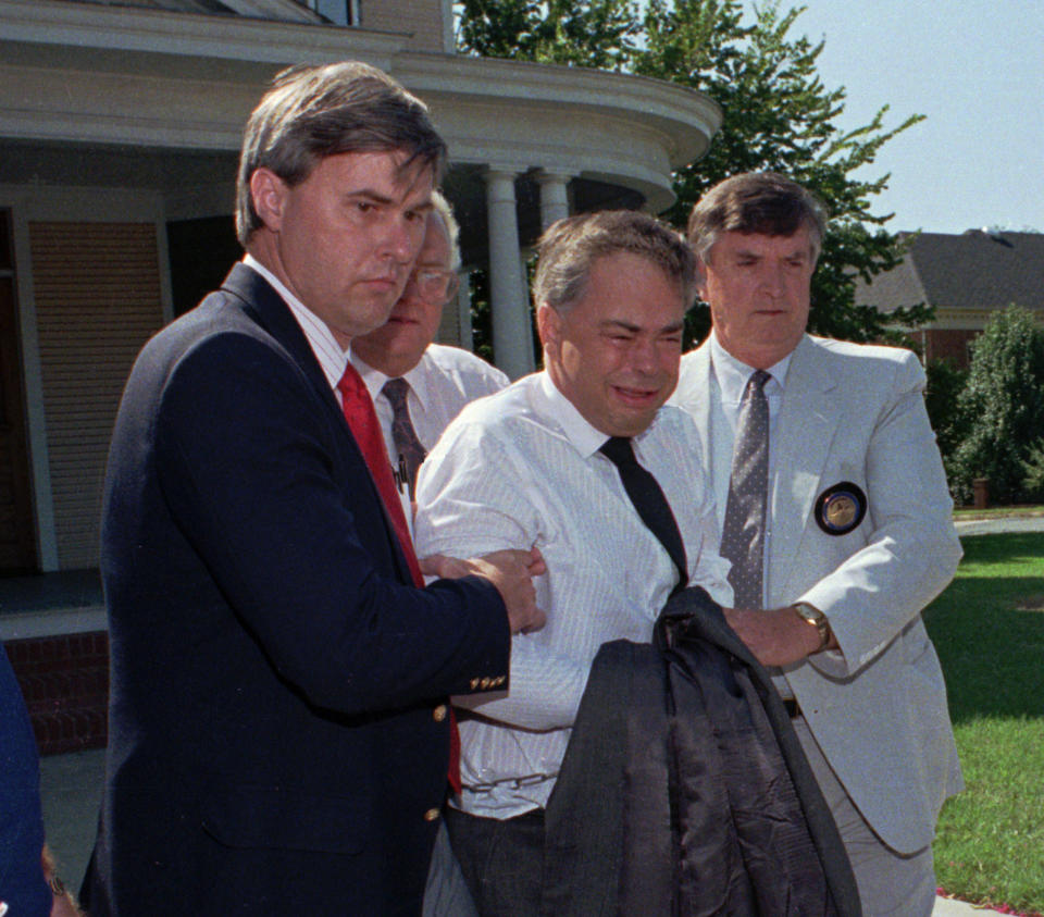 FILE - In this Thursday, Aug. 31, 1989 file photo, U.S. marshals escort former PTL leader Jim Bakker, center, from his attorney's office to a waiting car in Charlotte, N.C., after he did not appear in court. He was taken under order to the State Correctional Institute at Butner, N.C., for psychiatric evaluation. Bakker gained notoriety in the late 1980s and 1990s as a result of his trial and financial fraud conviction relating to Heritage USA, his TV studio, Christian-oriented theme park and water park attraction with shopping, hotels and condominiums in Fort Mill, S.C. (AP Photo/Chuck Burton)