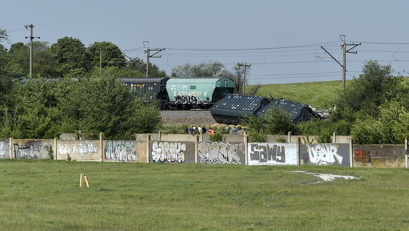 Derailed train cars carrying grain are seen next to the railroad track, in Crimea on Thursday, May 18, 2023. Quoting a source within the emergency services, state news agency RIA Novosti said that the incident occurred not far from the city of Simferopol. The Crimean Railway reported that the derailment was caused by “the interference of unauthorized persons” and that there were no casualties.