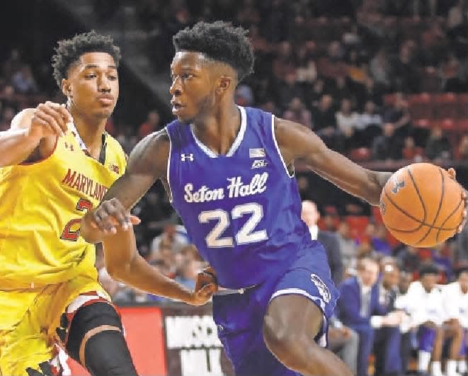 Seton Hall guard Myles Cale, right, drives past Maryland guard Aaron Wiggins.