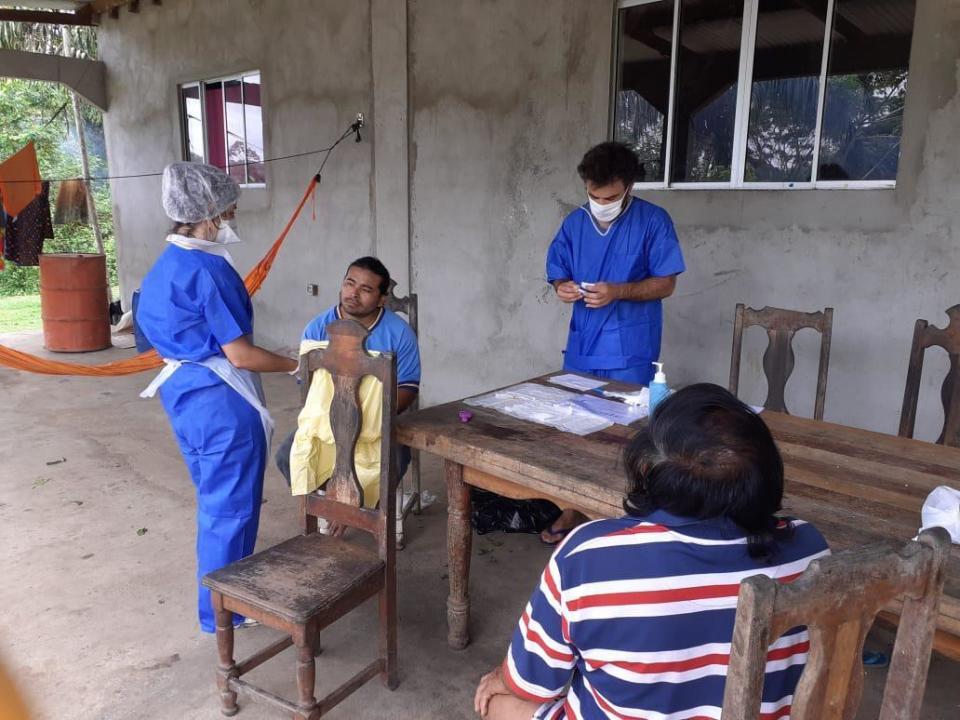 In this photo taken Wednesday, May 27, 2020, medial workers take care of residents of the remote village of Camopi, French Guiana. France's most worrisome virus hotspot is in fact on the border with Brazil - in French Guiana, a former colony where health care is scarce and poverty is rampant. The pandemic is exposing deep economic and racial inequality in French Guiana that residents say the mainland has long chosen to ignore. (AP Photo)
