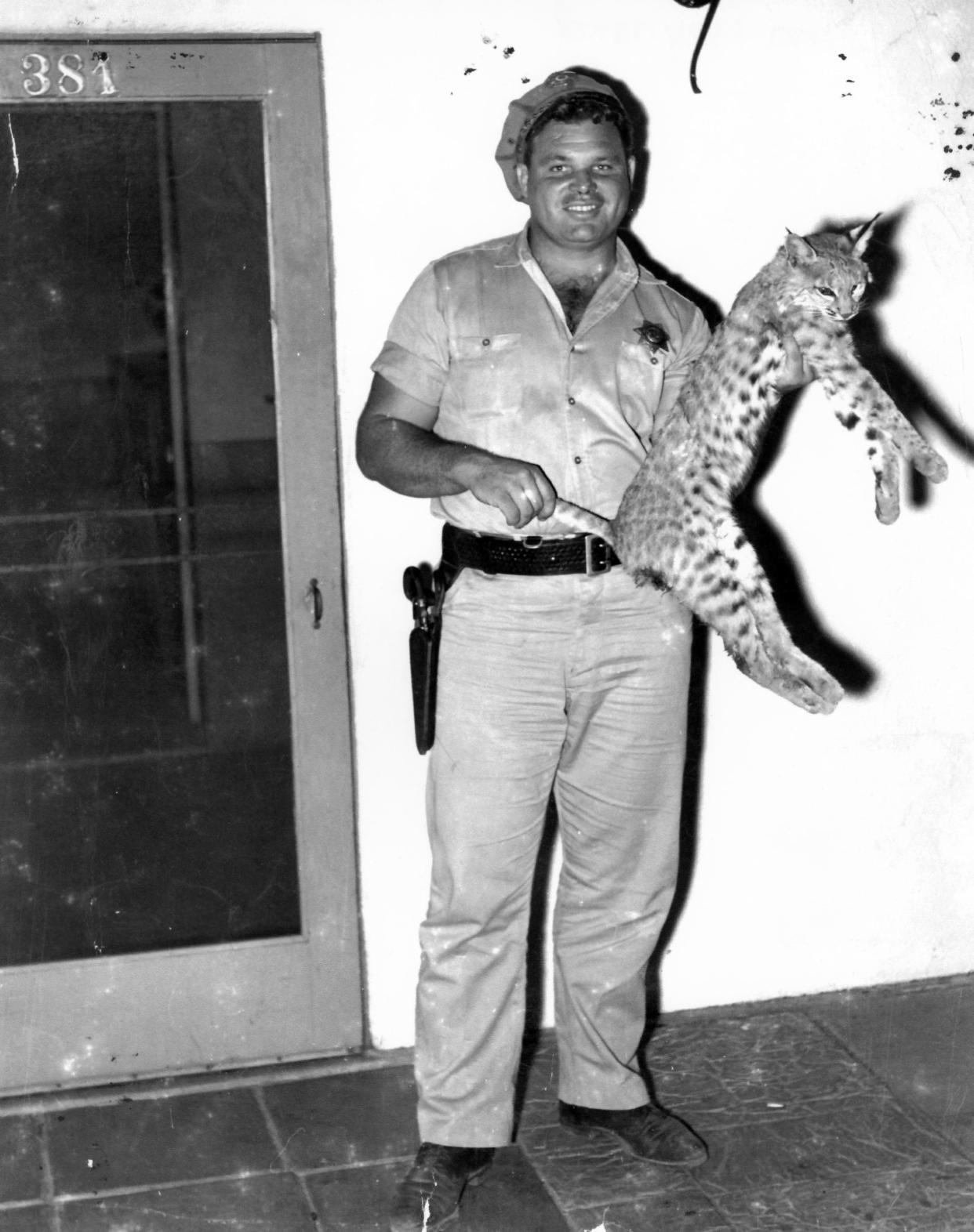 Big Jim Maynard with a bobcat.