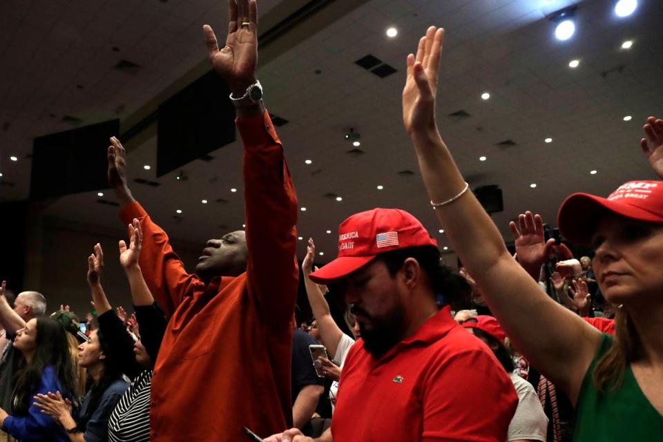 People raise their arms in prayer during a rally for evangelical supporters of President Donald Trump at the King Jesus International Ministry church, Friday, Jan. 3, 2020, in Miami. ((AP Photo/Lynne Sladky, File)