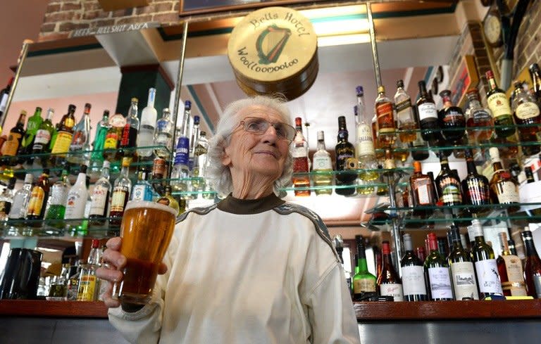 Sydney's oldest barmaid Lil Miles holds a beer at her family's Bells Hotel in Woolloomooloo, Sydney, on May 14, 2013. Miles has seen her city transform, witnessed the fall and rise of her neighbourhood and suffered family tragedy, but at the age of 91 Sydney's oldest barmaid has no plans to retire