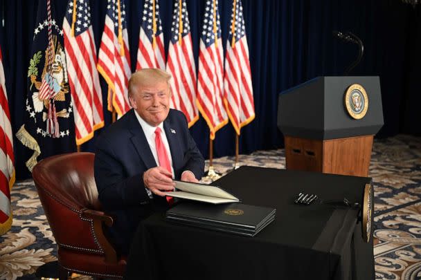 PHOTO: President Donald Trump signs executive actions extending coronavirus economic relief, during a news conference in Bedminster, N.J., on Aug. 8, 2020. (Jim Watson/AFP via Getty Images)