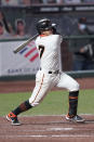 San Francisco Giants' Donovan Solano (7) hits a single to drive in a run against the Colorado Rockies during the fifth inning of a baseball game on Monday, Sept. 21, 2020, in San Francisco. (AP Photo/Tony Avelar)