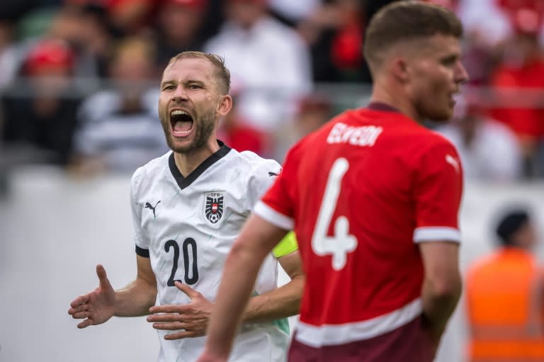 Austria's midfielder <a class="link " href="https://sports.yahoo.com/soccer/players/437351/" data-i13n="sec:content-canvas;subsec:anchor_text;elm:context_link" data-ylk="slk:Konrad Laimer;sec:content-canvas;subsec:anchor_text;elm:context_link;itc:0">Konrad Laimer</a> (L) and <a class="link " href="https://sports.yahoo.com/soccer/teams/switzerland/" data-i13n="sec:content-canvas;subsec:anchor_text;elm:context_link" data-ylk="slk:Switzerland;sec:content-canvas;subsec:anchor_text;elm:context_link;itc:0">Switzerland</a> defender <a class="link " href="https://sports.yahoo.com/soccer/players/438706/" data-i13n="sec:content-canvas;subsec:anchor_text;elm:context_link" data-ylk="slk:Nico Elvedi;sec:content-canvas;subsec:anchor_text;elm:context_link;itc:0">Nico Elvedi</a> featured at the Kybunpark (Fabrice COFFRINI)