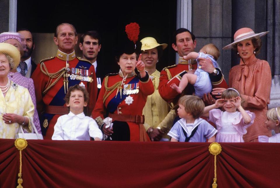 <p>During the Trooping the Colour ceremony, Queen Elizabeth II gathers with family: the Queen Mother, Prince Michael of Kent, Prince Philip, Lord Nicholas Windsor, Prince Edward, Princess Anne, Prince Charles, Prince Harry, Princess Diana, and Prince William. </p>